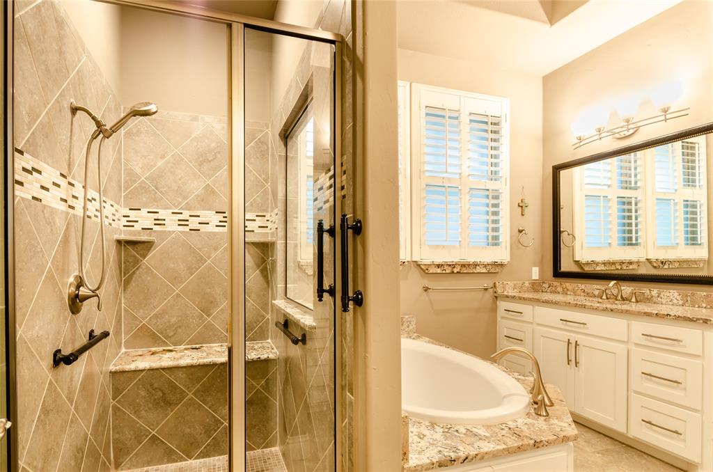 1863 Audubon Pond Way Allen, TX 75013 - Photo 25 of 40 a bathroom with a granite countertop sink a mirror and a shower