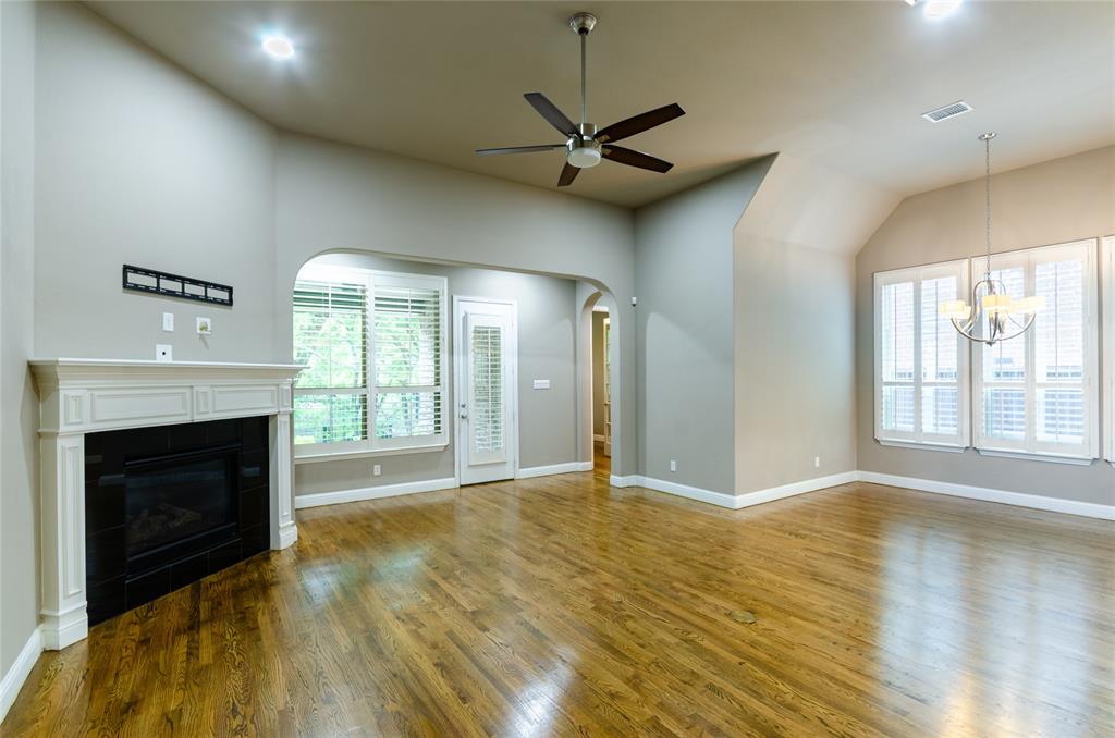 1863 Audubon Pond Way Allen, TX 75013 - Photo 9 of 40 a view of an empty room with a fireplace and a window