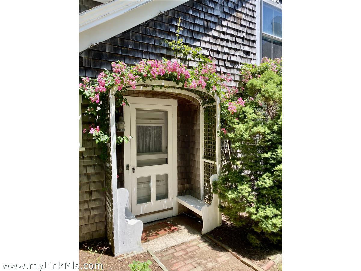 13 Cliff Road Nantucket, MA 02554 - Photo 6 of 38 a view of a house with a flower garden