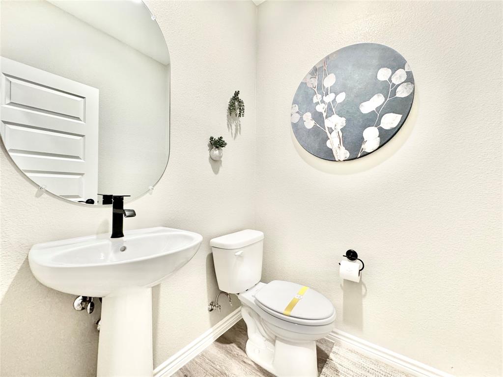 8523 Leyton Road The Colony, TX 75056 - Photo 13 of 39 a bathroom with a toilet and a sink