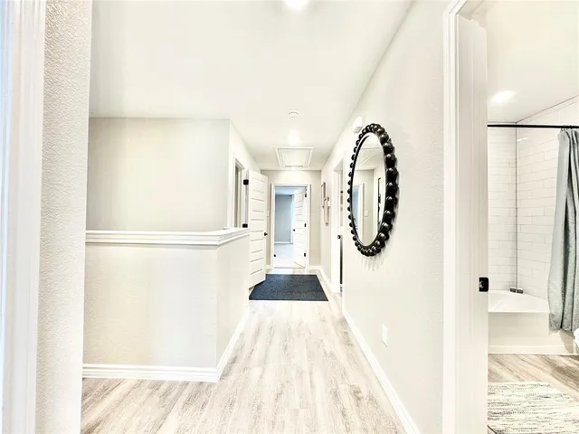 a view of gallery with wooden floor