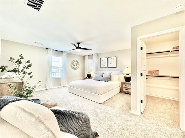 a bedroom with a large bed and a chandelier