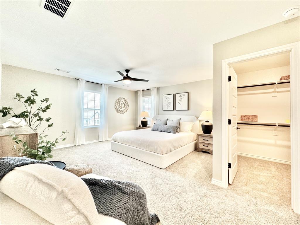 8523 Leyton Road The Colony, TX 75056 - Photo 17 of 39 a bedroom with a large bed and a chandelier