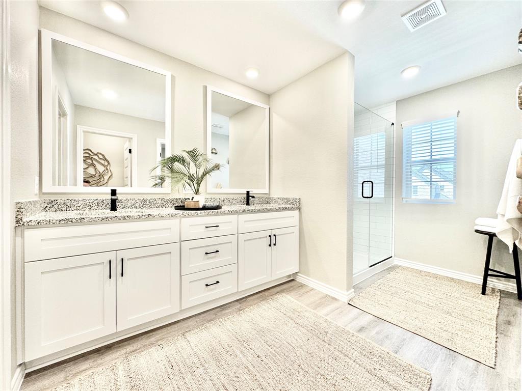 8523 Leyton Road The Colony, TX 75056 - Photo 22 of 39 a bathroom with a granite countertop sink mirror and