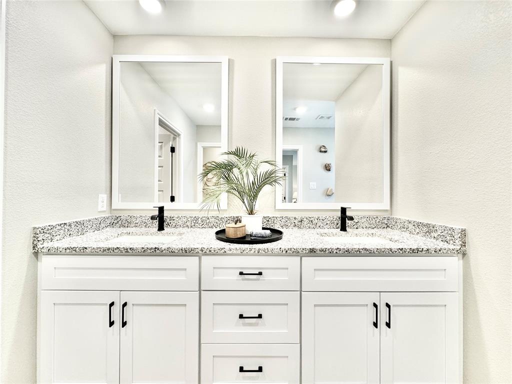 8523 Leyton Road The Colony, TX 75056 - Photo 24 of 39 a bathroom with a granite countertop sink and a mirror