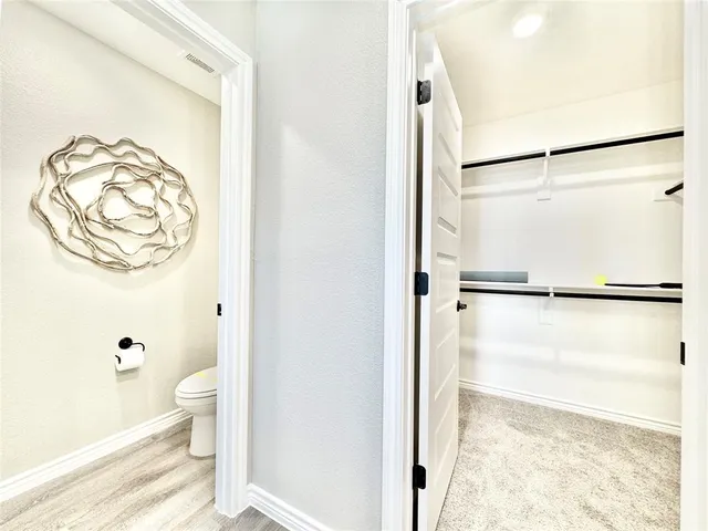 a bathroom with a granite countertop shower and a toilet