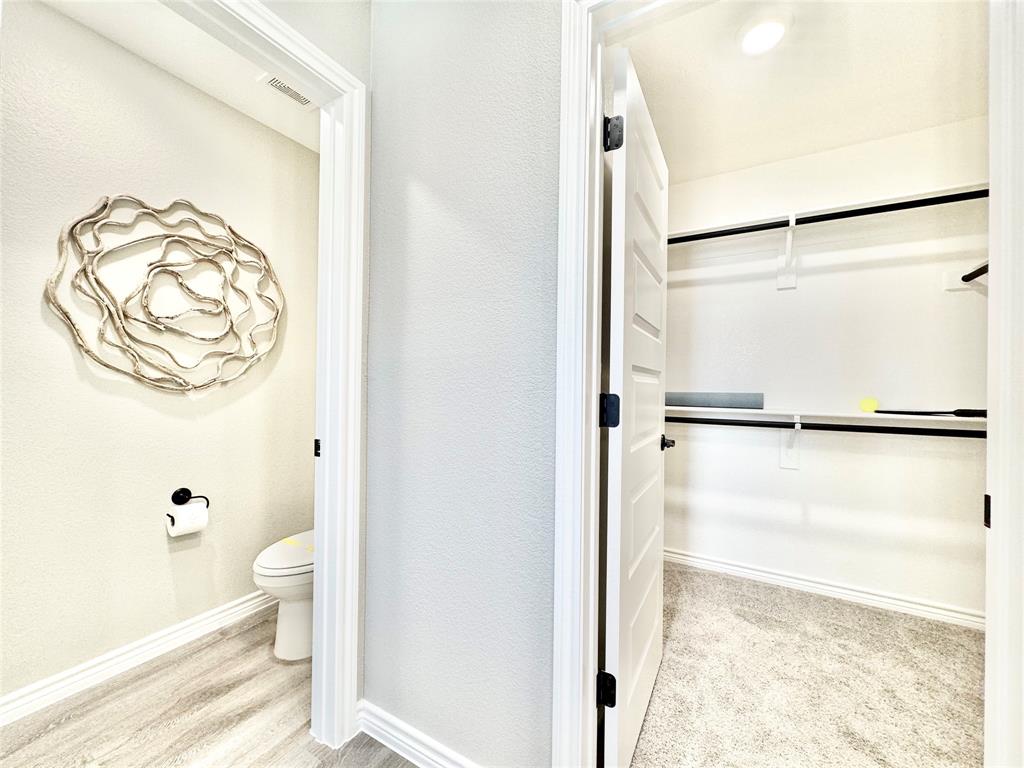 8523 Leyton Road The Colony, TX 75056 - Photo 25 of 39 a bathroom with a granite countertop shower and a toilet