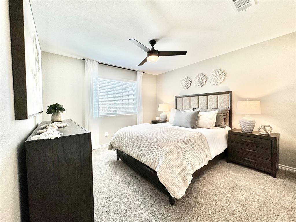 8523 Leyton Road The Colony, TX 75056 - Photo 30 of 39 a bedroom with a bed and a chandelier