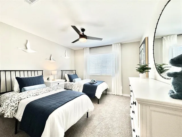 a bed room with two beds and a chandelier