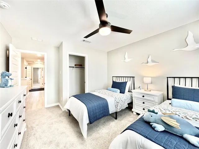 a spacious bedroom with a bed couch and window