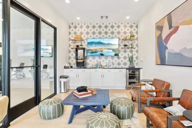 a living room with furniture and a chandelier