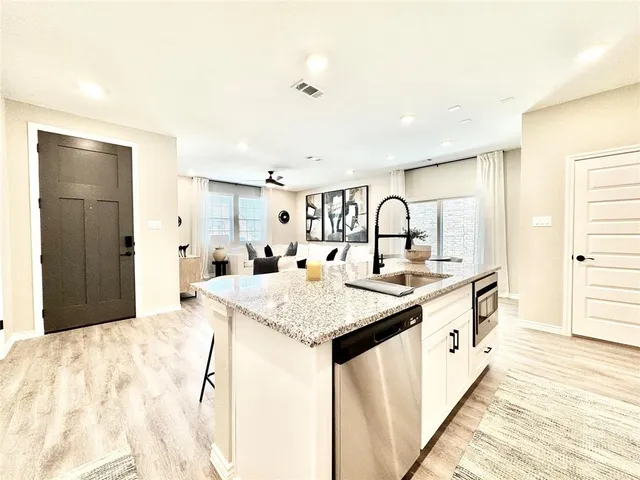 a large bathroom with a granite countertop sink a large mirror and a shower