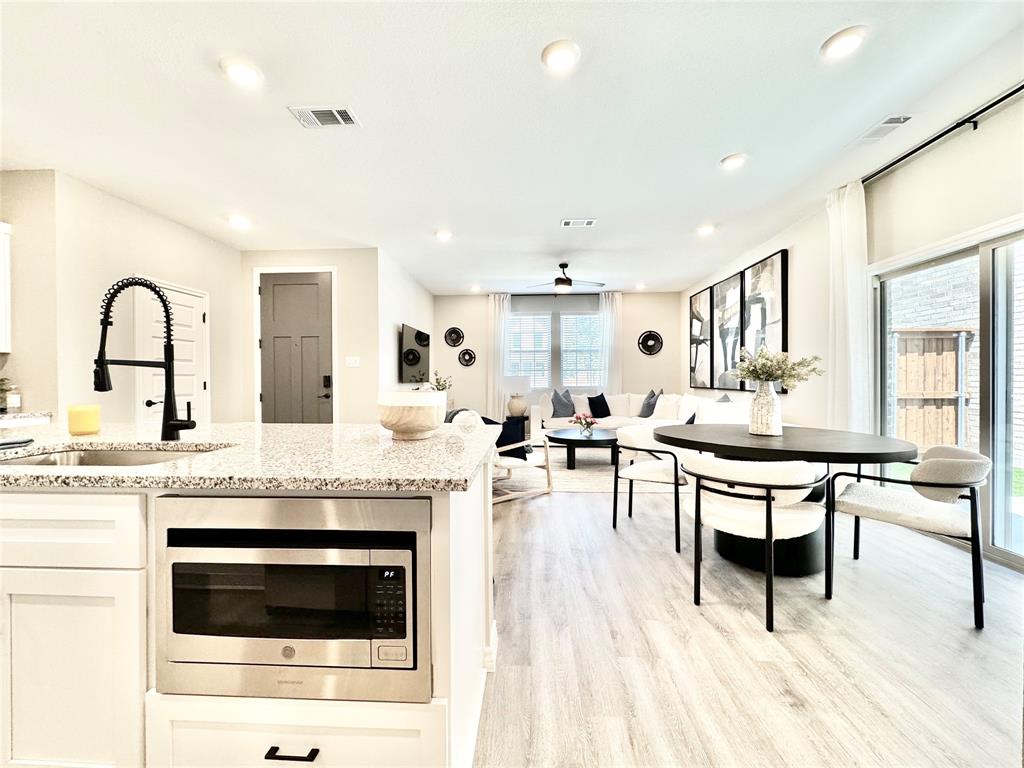 8523 Leyton Road The Colony, TX 75056 - Photo 10 of 39 a living room with stainless steel appliances kitchen island granite countertop furniture and a kitchen view