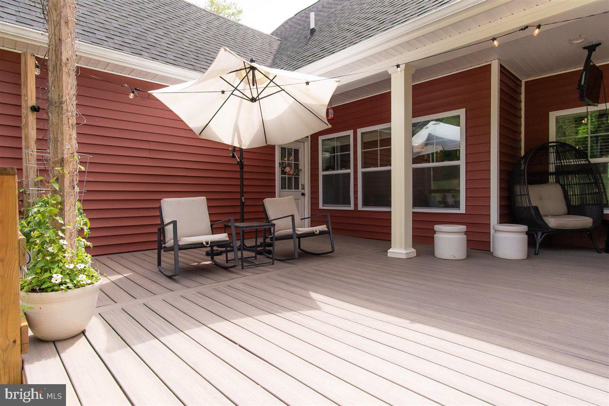 2390 Shirley Road Charles Town, WV 25414 - Photo 63 of 69 a view of a patio with a table and chairs under an umbrella