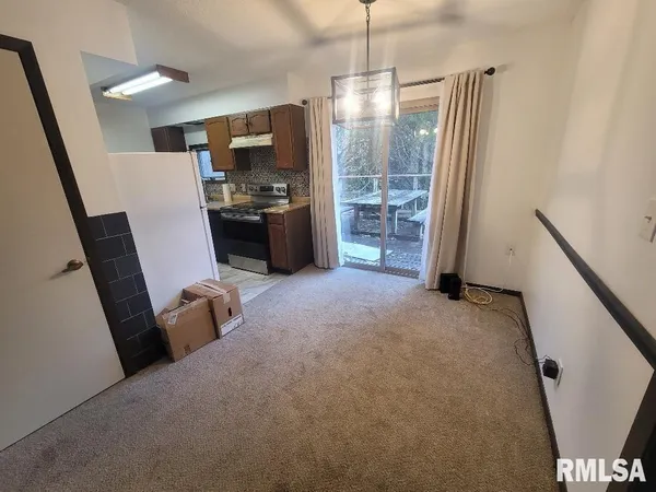 a kitchen with a refrigerator and microwave