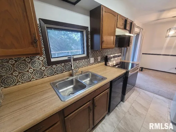 a kitchen with a sink stove and microwave