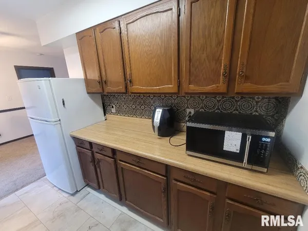 a kitchen with stainless steel appliances a stove a microwave a sink and cabinets