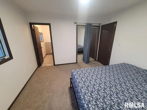 a bedroom with a bed and a mirror
