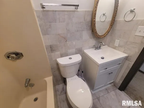 a white toilet sitting next to a shower curtain