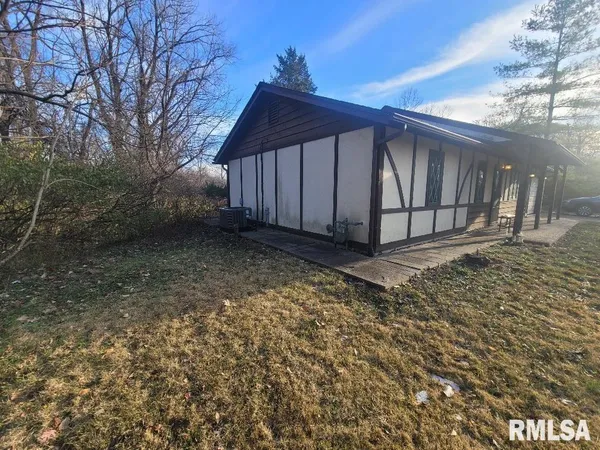 a view of a house with a small yard and wooden fence