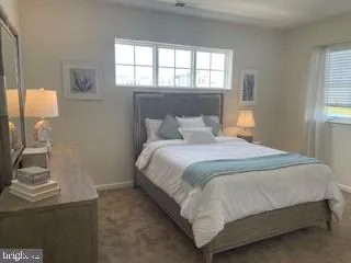 a bedroom with a bed chair and window