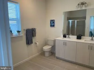 a bathroom with a sink toilet and mirror