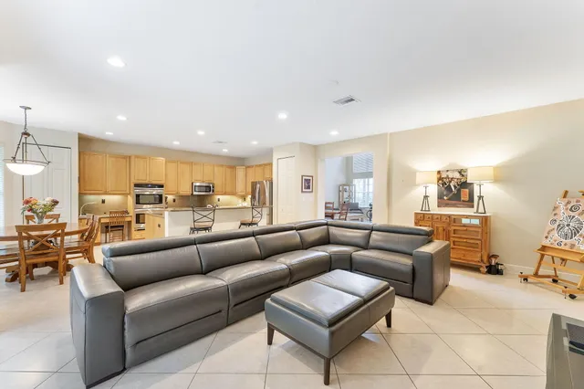 a living room with furniture kitchen view and a table