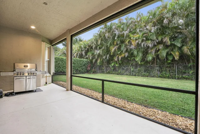 a view of a porch with furniture and garden