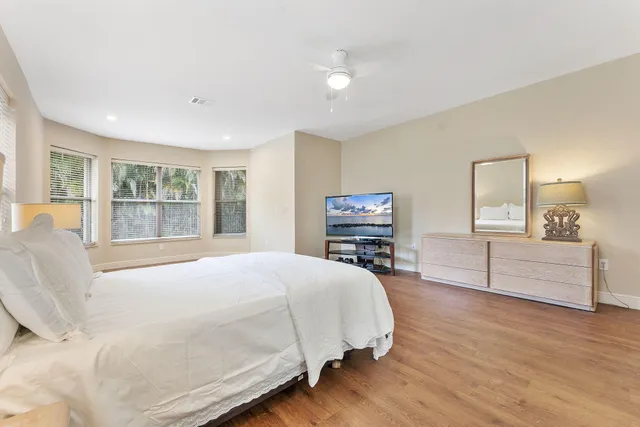 a bedroom with a large bed and a large window
