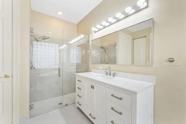 a bathroom with a shower sink double and mirror