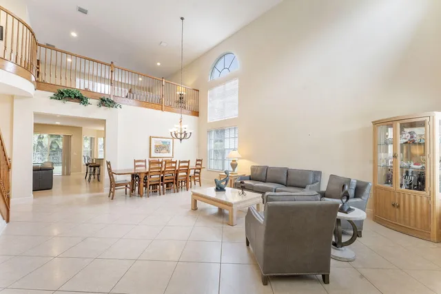 a living room with furniture and a chandelier