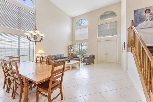 a dining room with furniture a chandelier and wooden floor