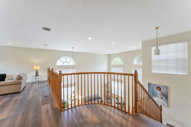 a view of staircase with lots of wooden floor and a chandelier