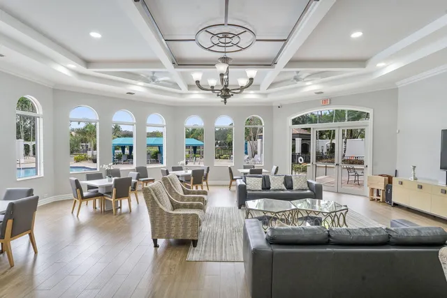 a living room with furniture and a chandelier