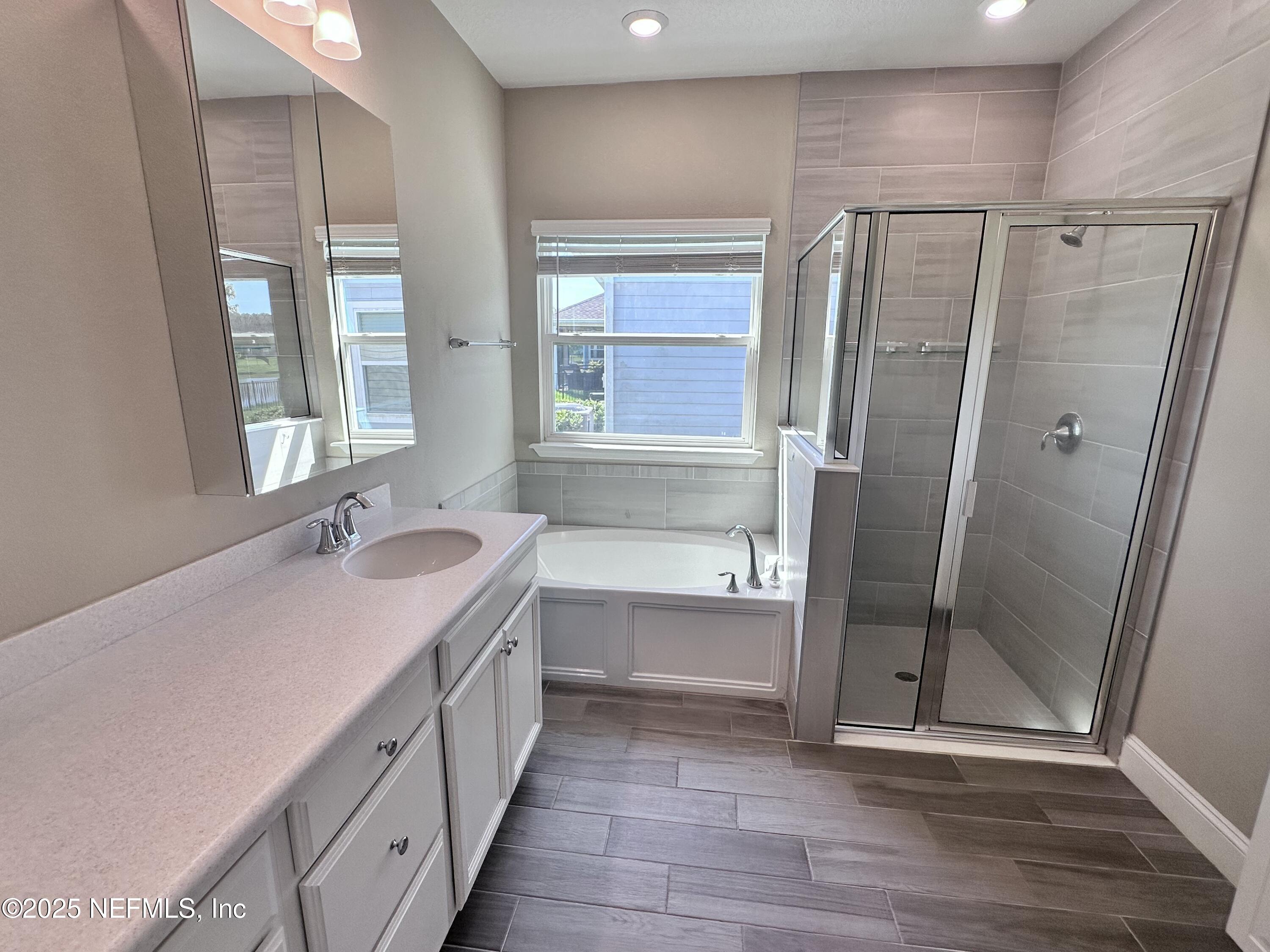 510 Broomsedge Circle St. Augustine, FL 32095 - Photo 17 of 28 a bathroom with double vanity and a shower