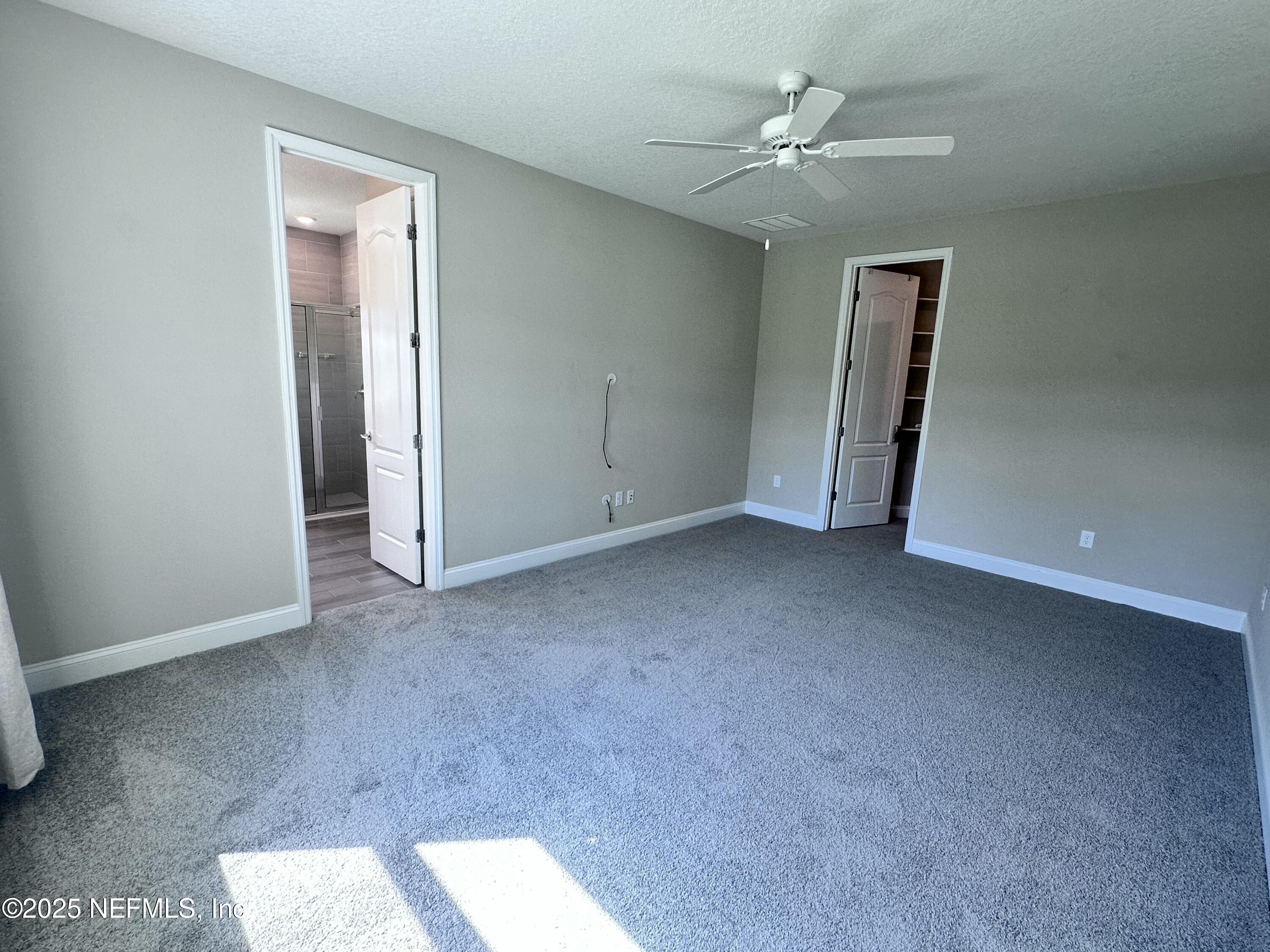 510 Broomsedge Circle St. Augustine, FL 32095 - Photo 19 of 28 an empty room with closet and a ceiling fan