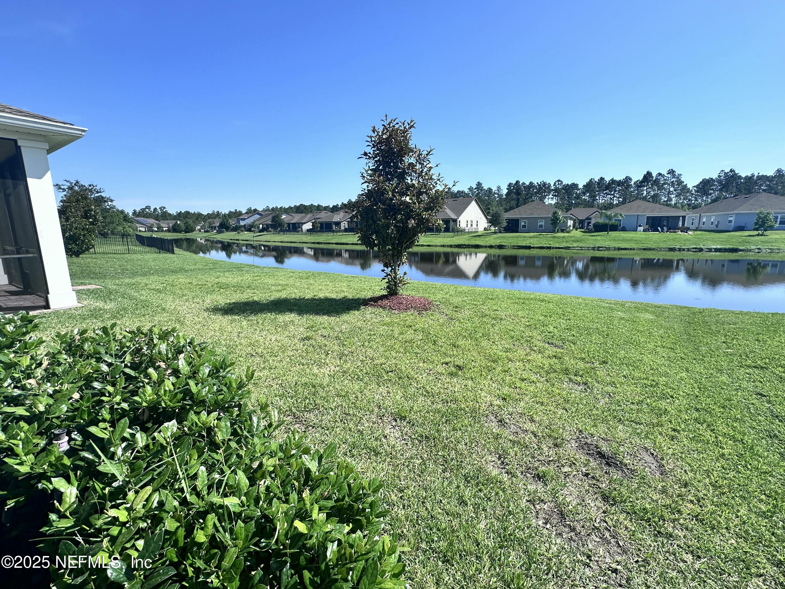 510 Broomsedge Circle St. Augustine, FL 32095 - Photo 23 of 28 a view of a lake with a house in the background