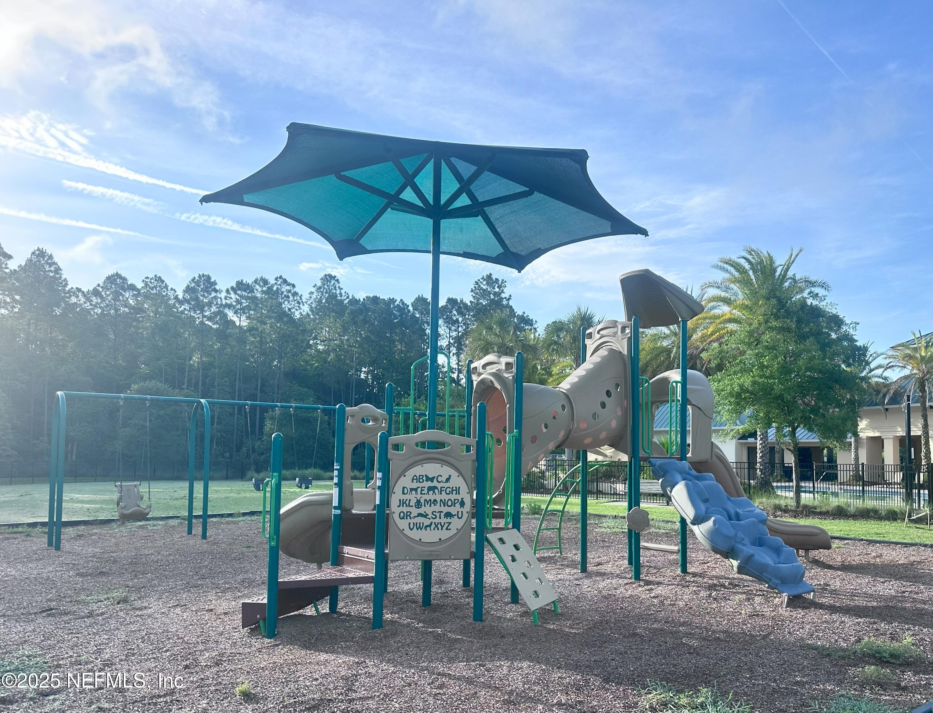 510 Broomsedge Circle St. Augustine, FL 32095 - Photo 28 of 28 a view of a table and chairs under an umbrella