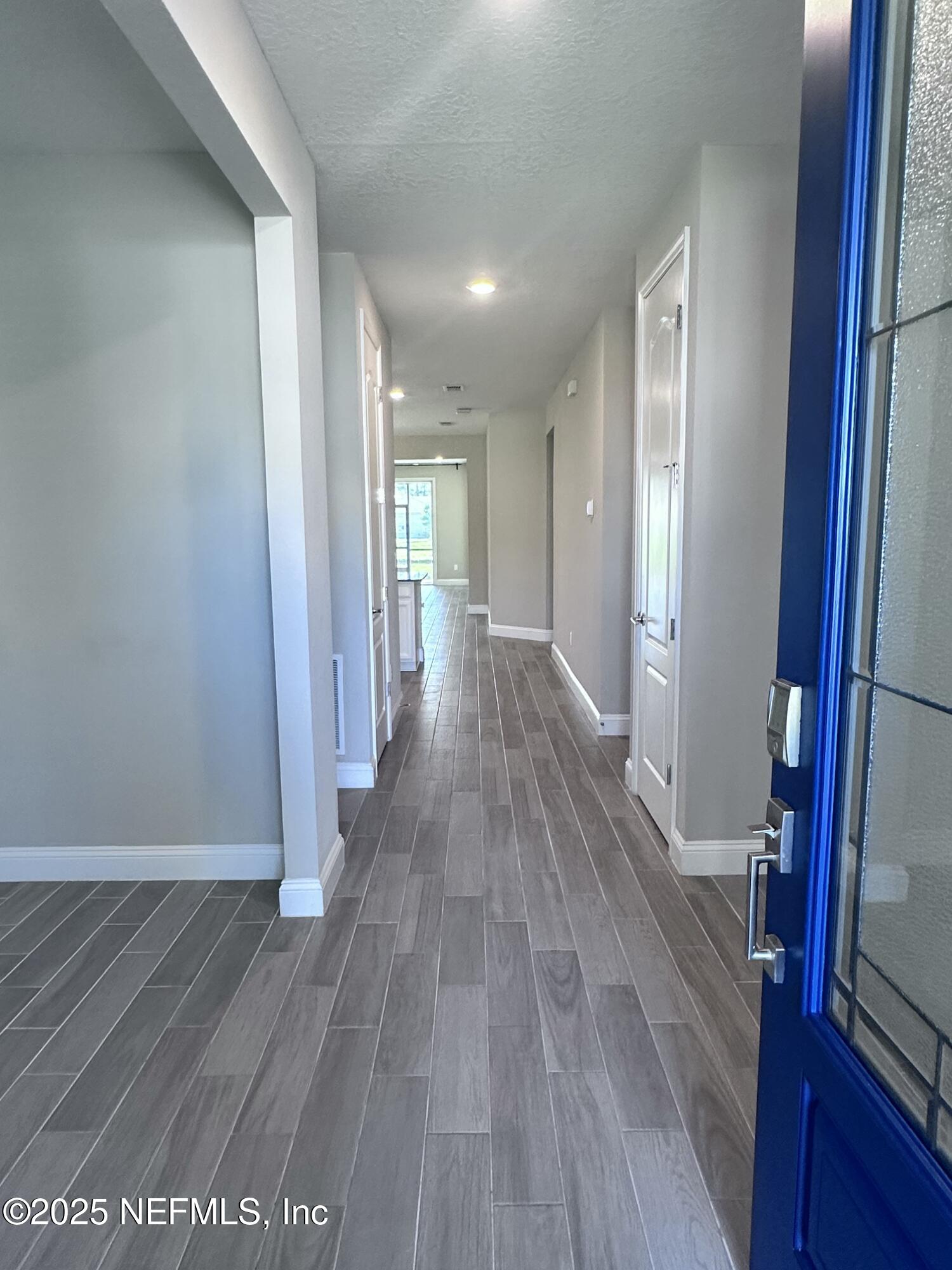 510 Broomsedge Circle St. Augustine, FL 32095 - Photo 3 of 28 a view of a hallway with wooden floor