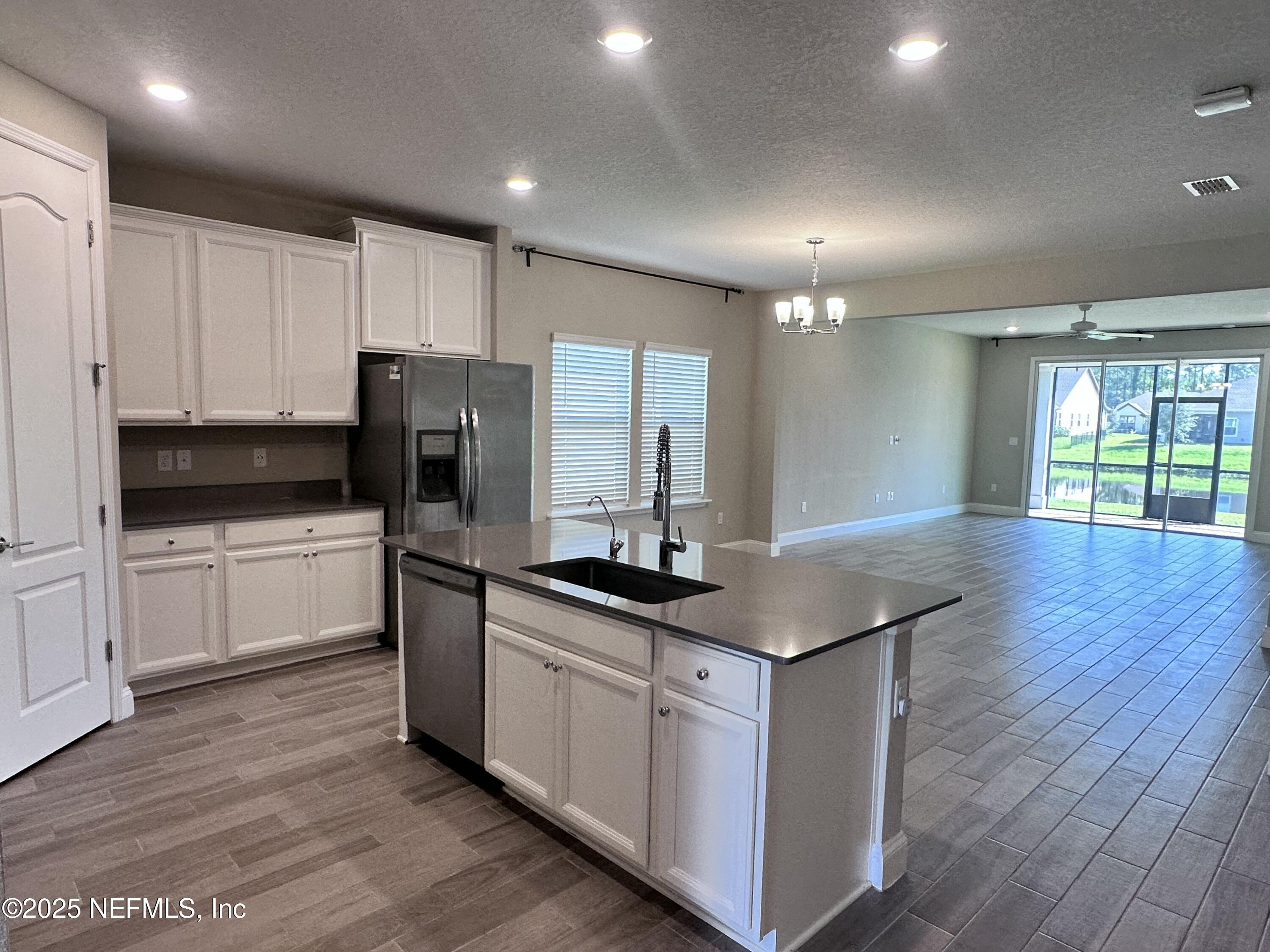 510 Broomsedge Circle St. Augustine, FL 32095 - Photo 7 of 28 a kitchen with stainless steel appliances granite countertop a sink a stove and refrigerator