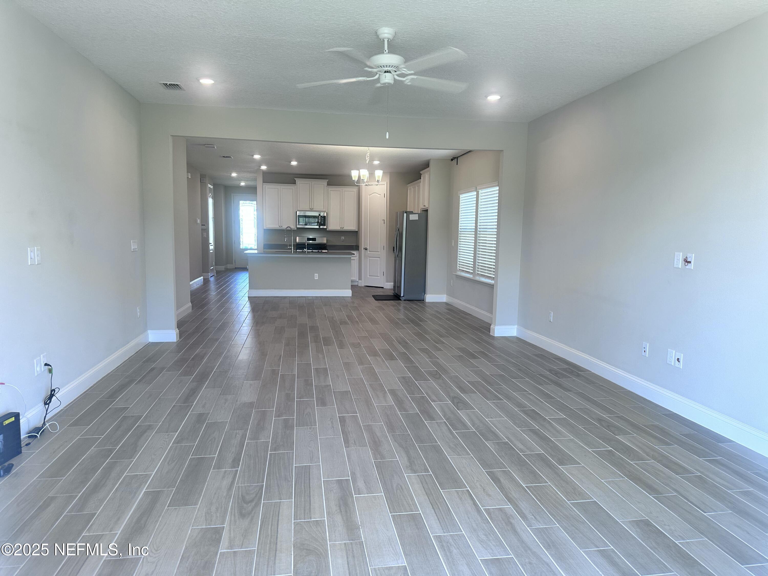 510 Broomsedge Circle St. Augustine, FL 32095 - Photo 10 of 28 a view of a living room a kitchen and a sink