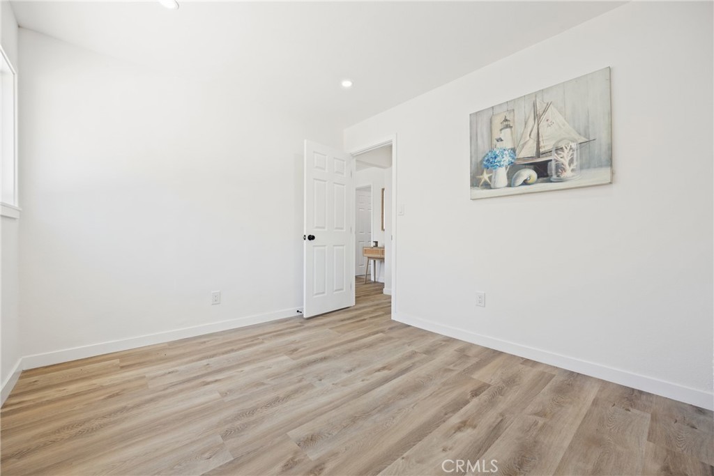 220 South Harris Avenue Compton, CA 90221 - Photo 24 of 28 an empty room with wooden floor and painting on the wall
