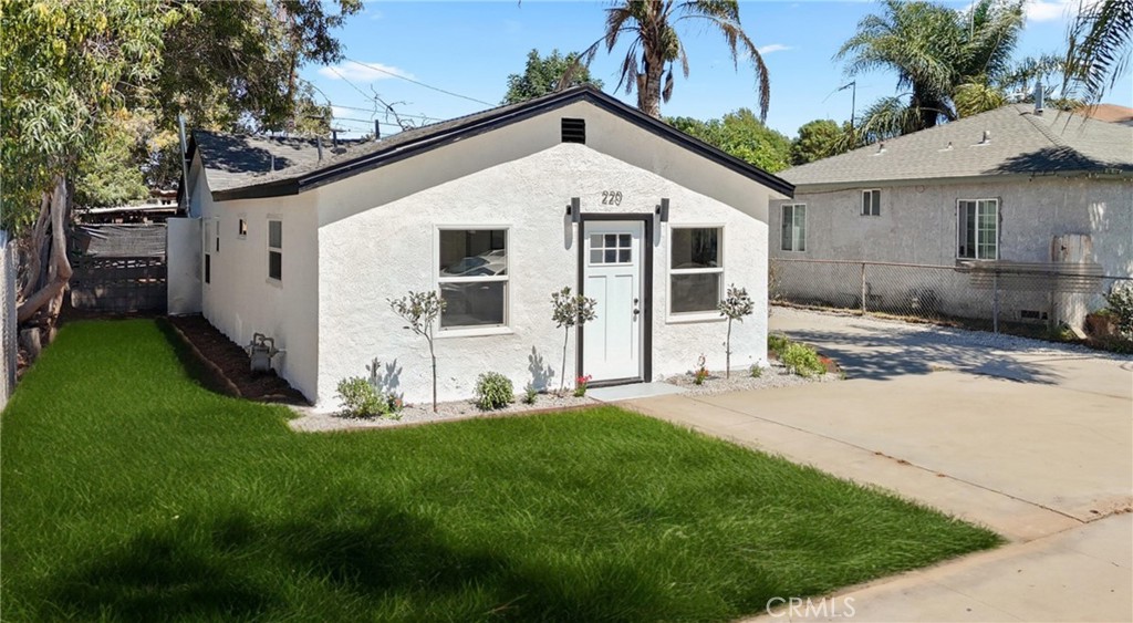 220 South Harris Avenue Compton, CA 90221 - Photo 3 of 28 a front view of a house with a yard and garage