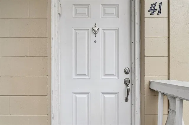 a dining room with wooden floor a chandelier a wooden table and chairs