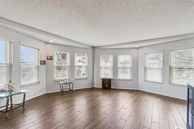 a kitchen with granite countertop a refrigerator and a stove top oven