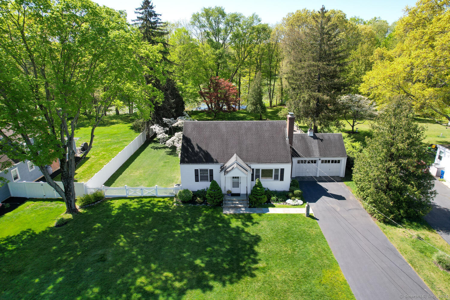 a view of a house with a big yard and a large tree