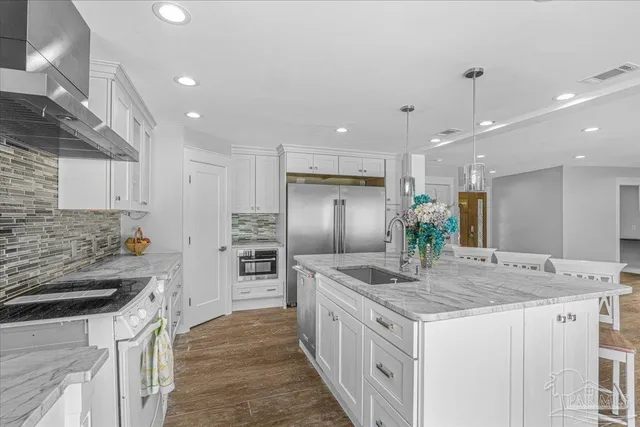 a kitchen with granite countertop white cabinets and white appliances