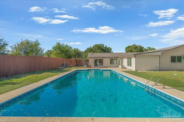 a backyard of a house with table and chairs
