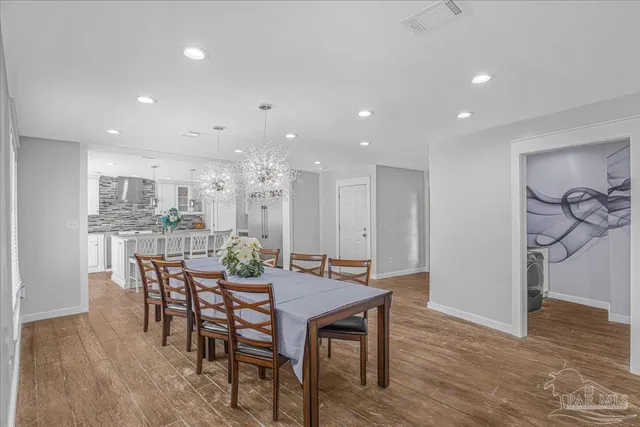 a kitchen with kitchen island counter top space and wooden floor