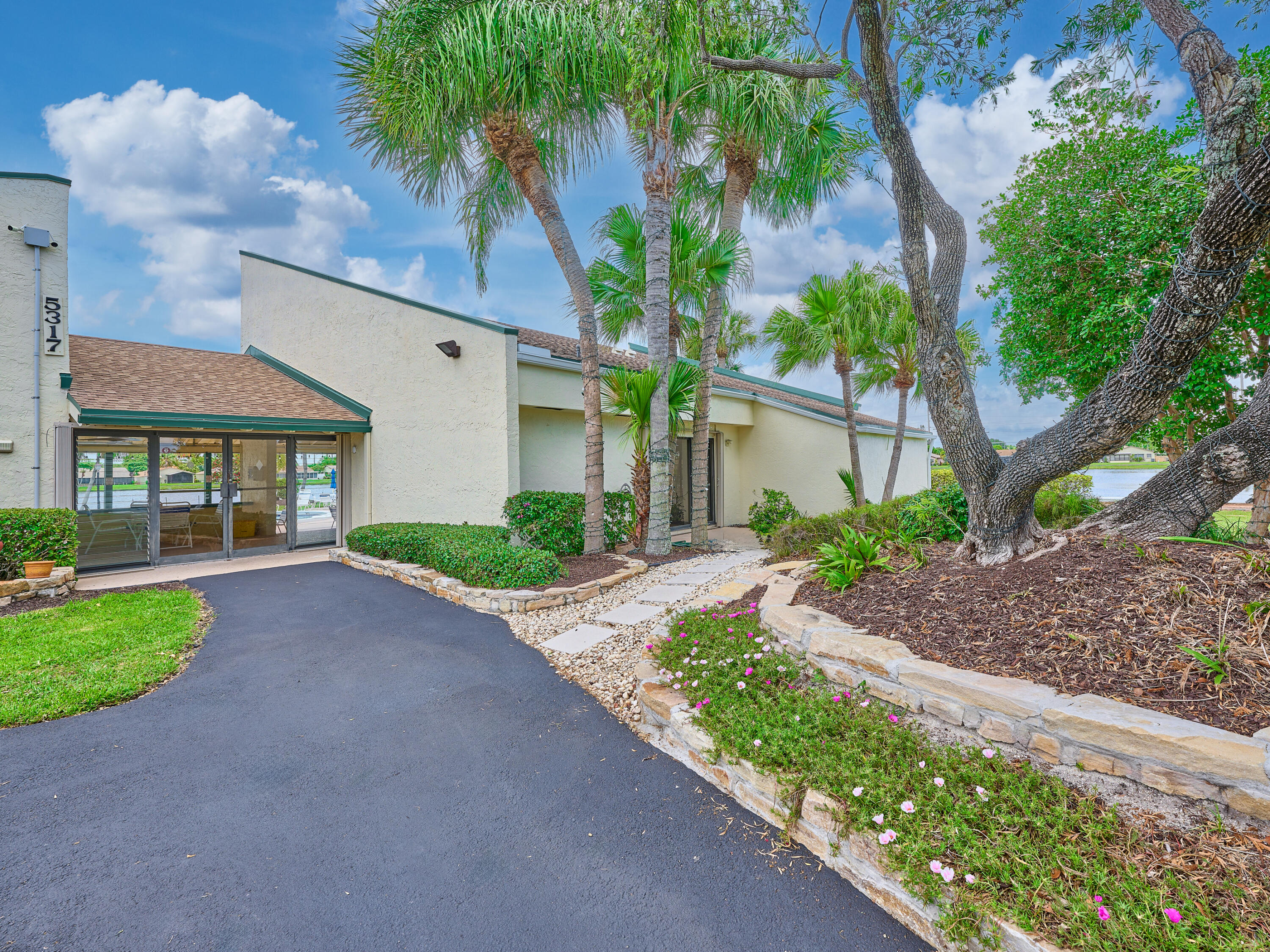 5197 Minto Road Boynton Beach, FL 33472 - Photo 25 of 32 a view of a house with a small yard and a large tree